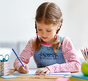 Little girl writing in notebook