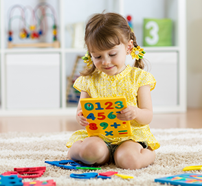 Little girl playing with number blocks